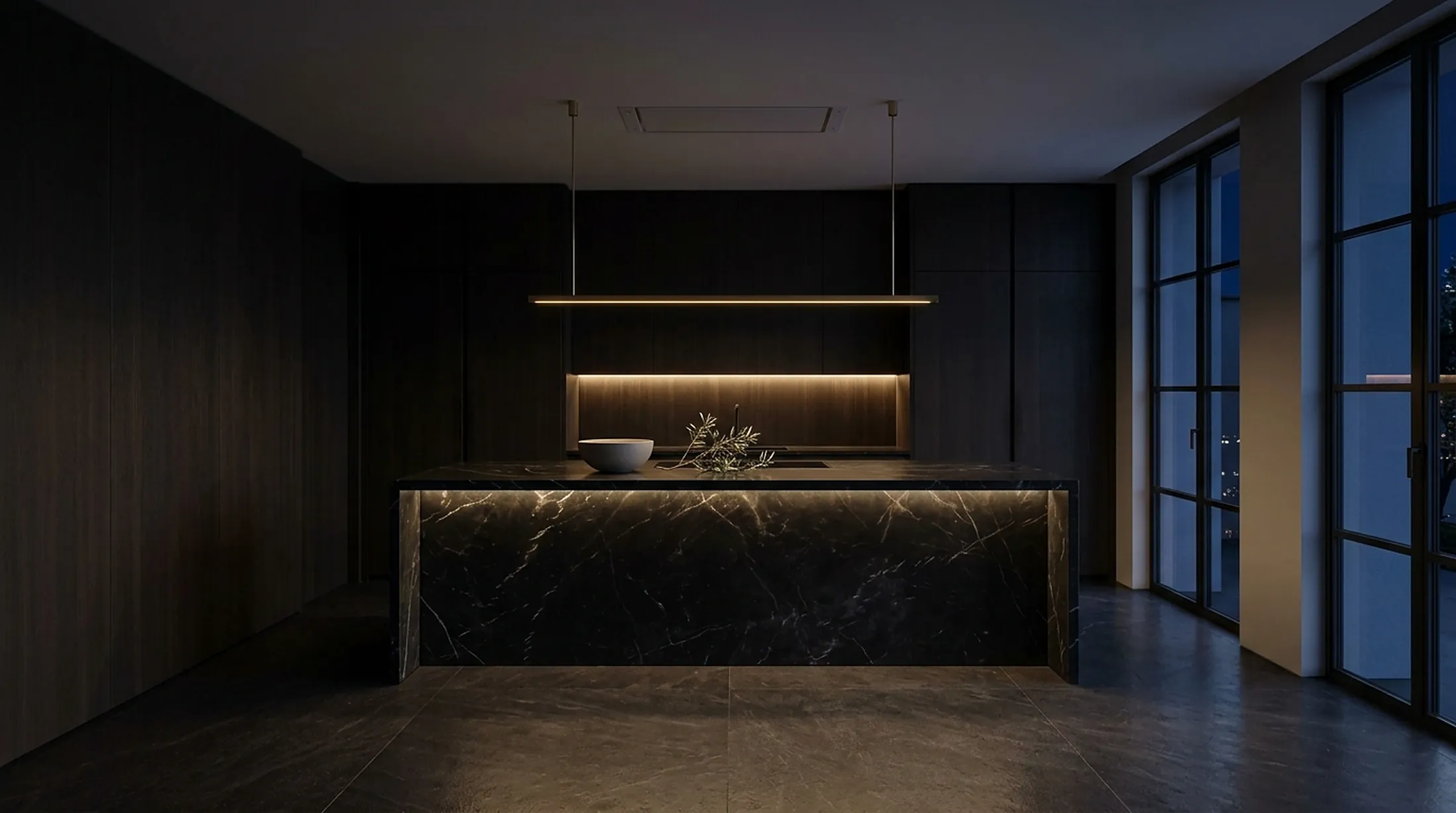 The same kitchen at night with warm concealed lighting