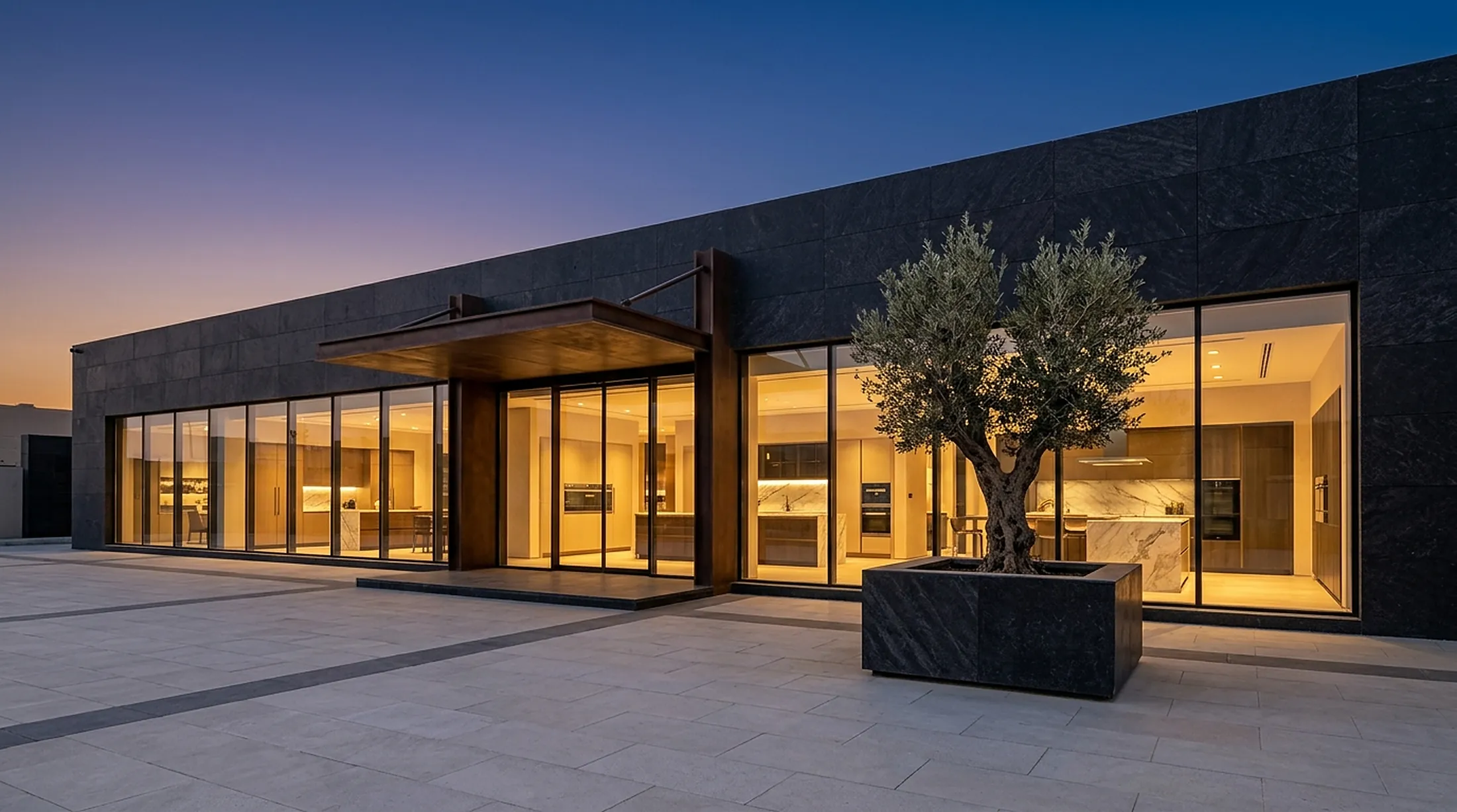 Ombrera showroom at dusk with an olive tree