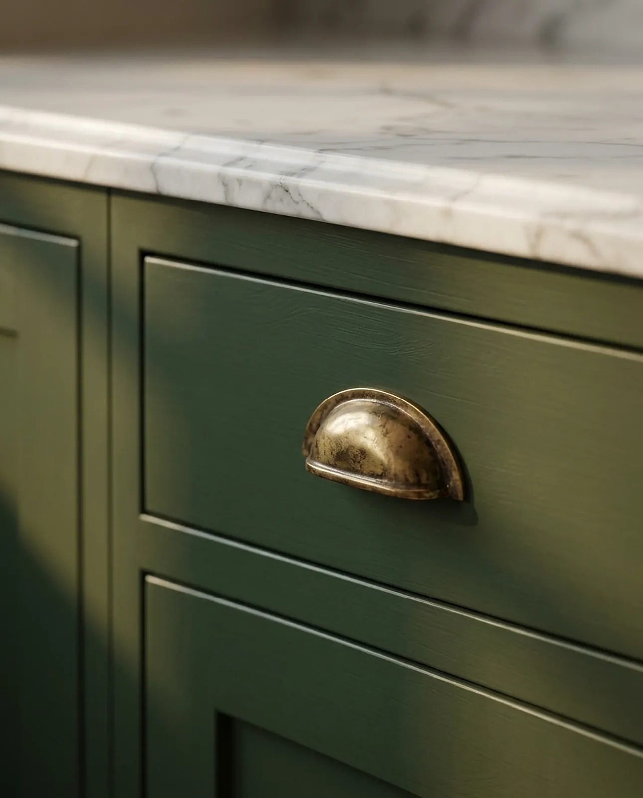 Green inset drawer with an aged brass cup handle